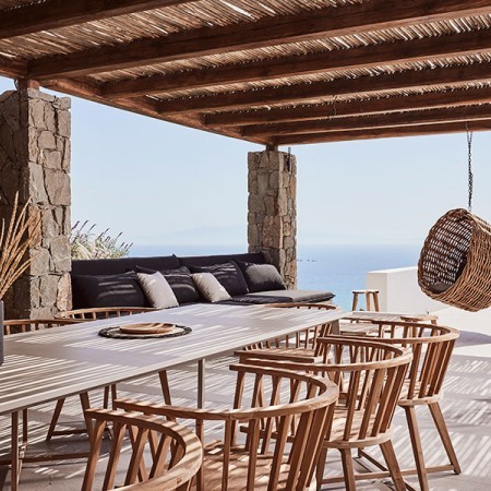 exterior dining area with pergola and sea view
