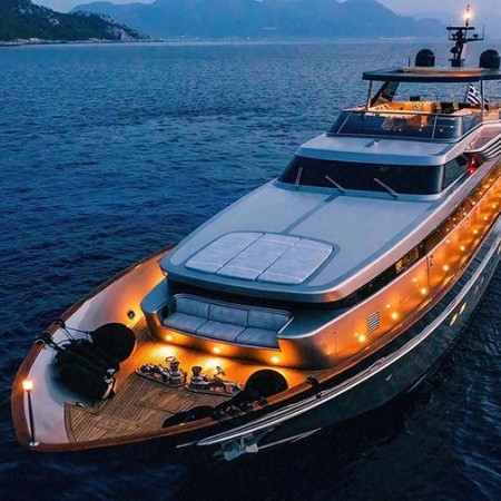 Oval superyacht at night